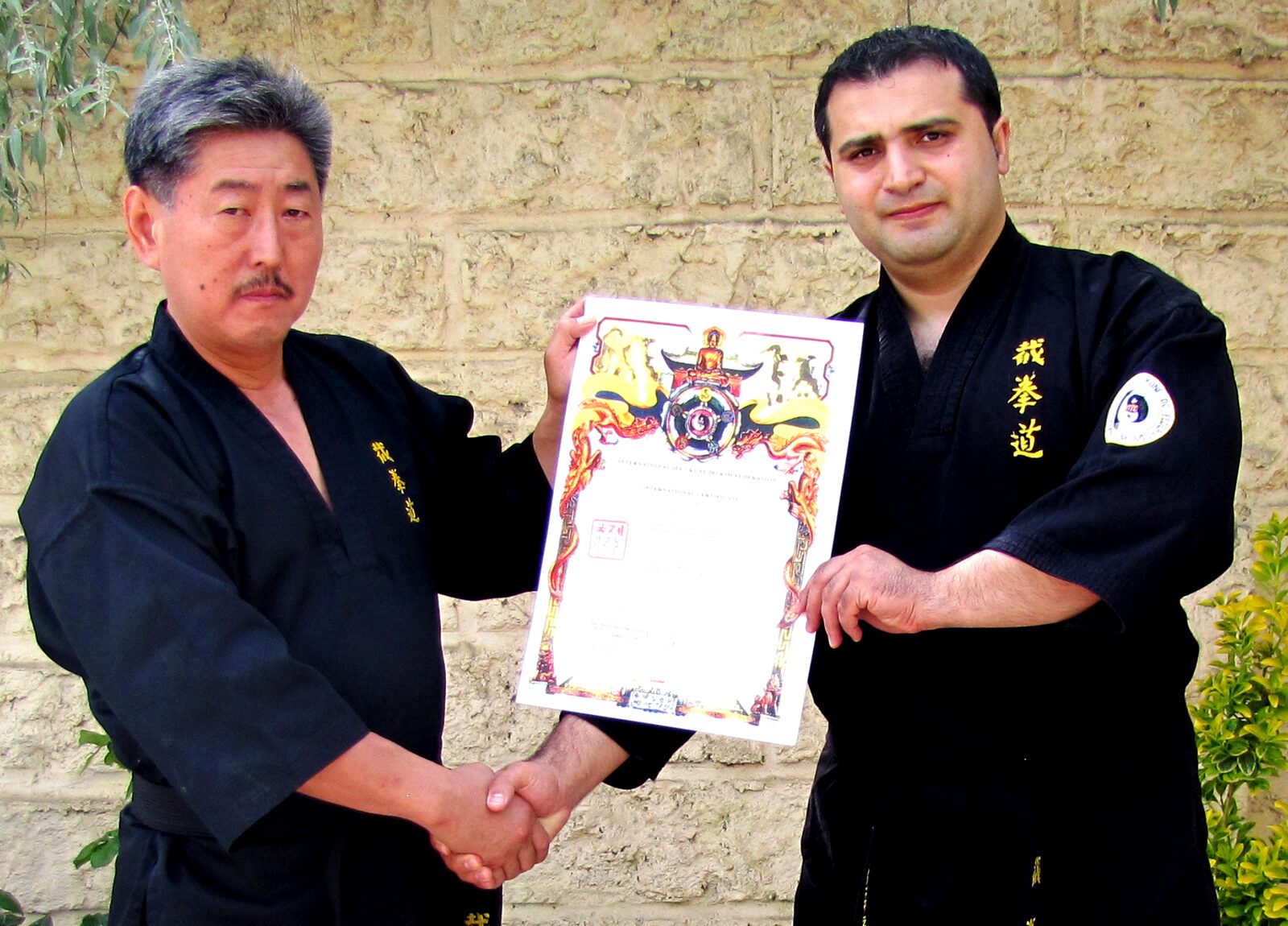 Grandmaster Vidadi Hajiyev receiving his 8th Dan certificate from Grandmaster Mikhail Kim